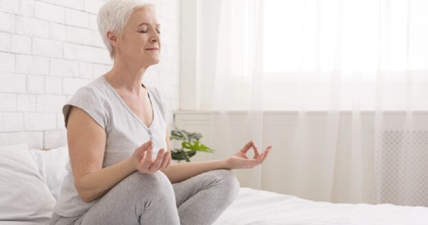 Senior woman practicing yoga in the morning