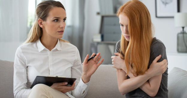 Young teenage girl talking to therapist